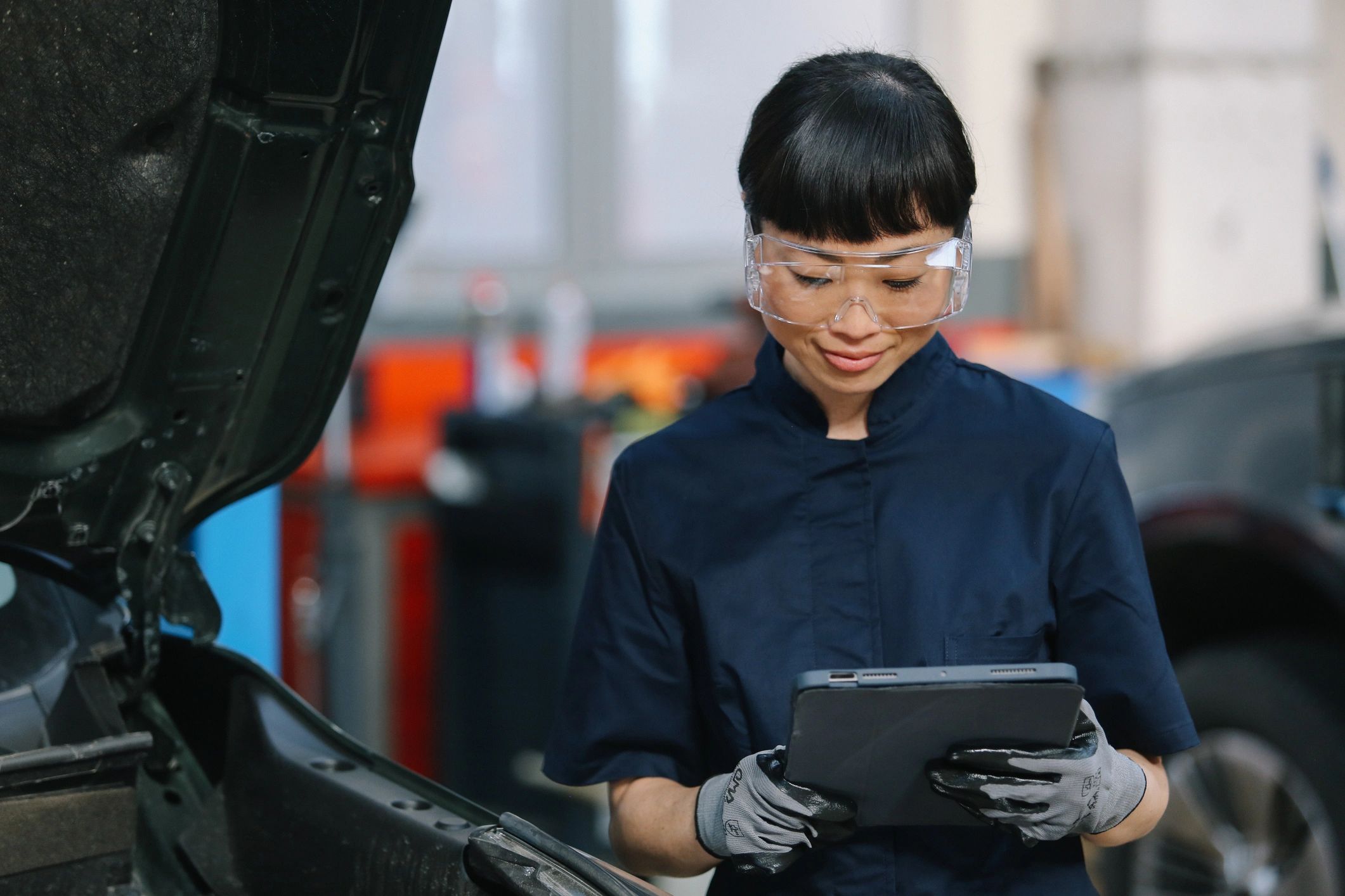 Mechanic performing vehicle inspection in a repair shop
