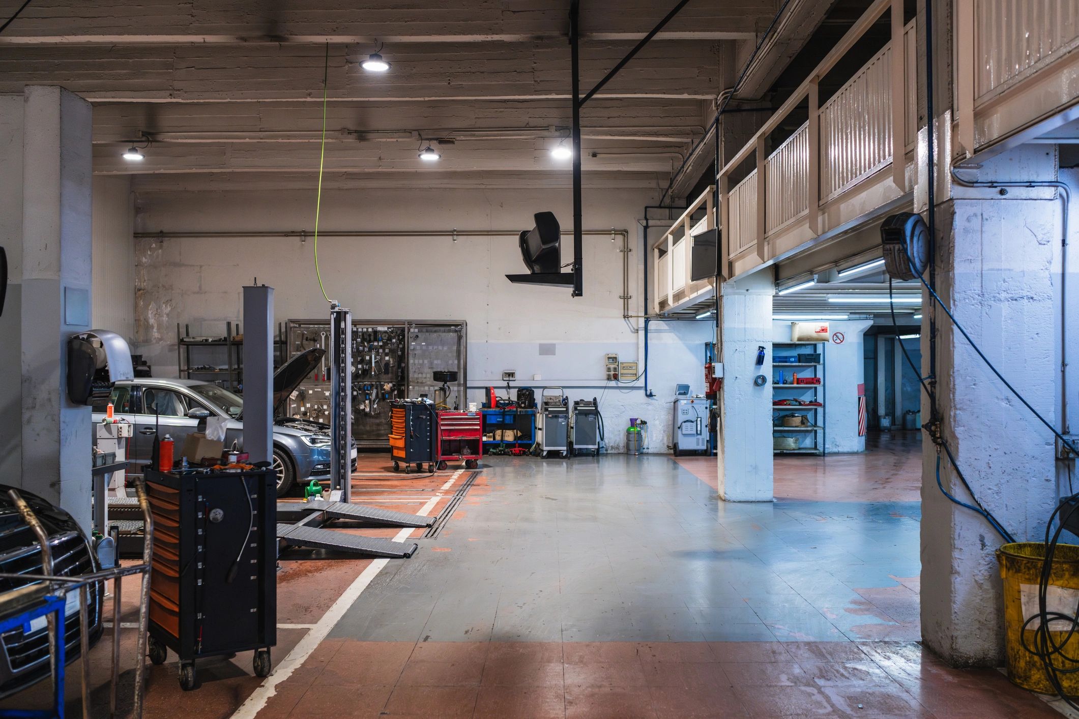 Car repair shop service bays with lifts and toolboxes
