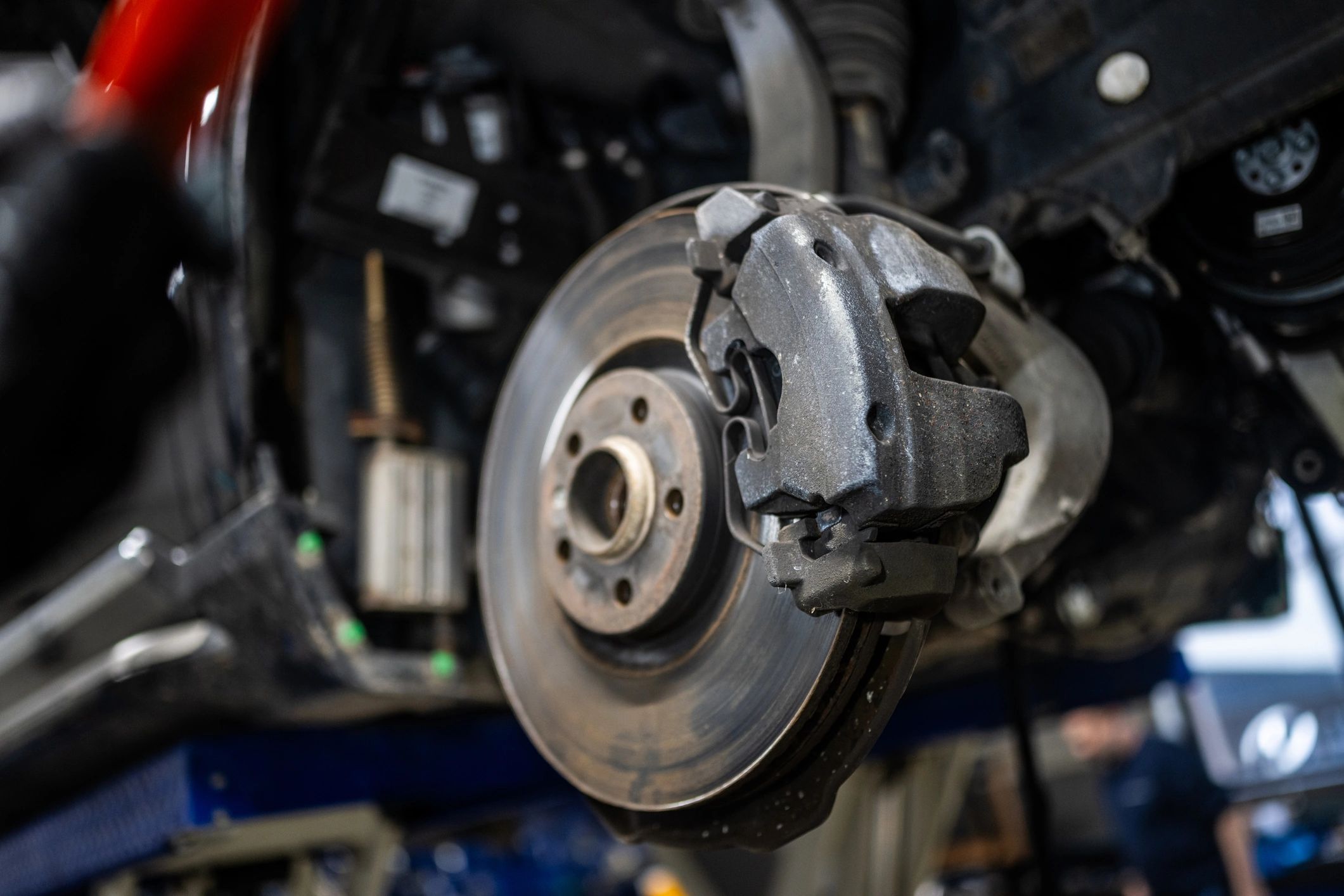 Brake disc and caliper in a repair shop setting
